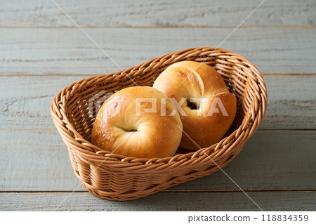 Freshly baked bagels in a basket Freshly baked bagels in a basket 118834359