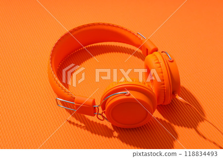 On-top, large, bright orange headphones, on a light background. On-top, large, bright orange headphones, on a light background. 118834493