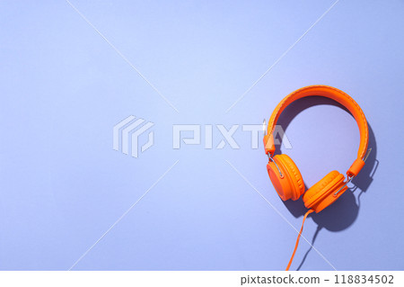 On-top, large, bright orange headphones, on a light background. On-top, large, bright orange headphones, on a light background. 118834502