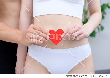 Couple supporting woman's belly with care, couple holding heart together, couple, pregnancy, infertility treatment, trimming 118835294