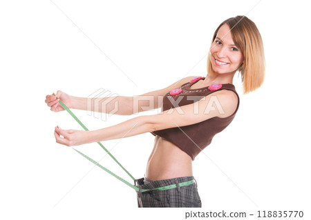 Pretty woman shows her weight loss wearing measure tapes isolated 118835770