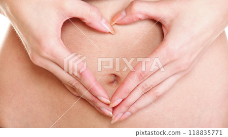 Sexy young woman heart shape hands belly Sexy young woman heart shape hands belly 118835771