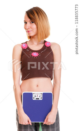 Happy woman carrying a scale against white background Happy woman carrying a scale against white background 118835773