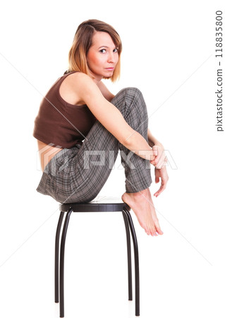 worried and afraid young woman sitting on chair. Isolated worried and afraid young woman sitting on chair. Isolated 118835800