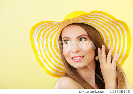 Woman in big yellow summer hat. Woman in big yellow summer hat. 118836106