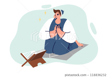 Muslim boy reads quran on knees, studying islam and commandments of prophet muhammad from book 118836232