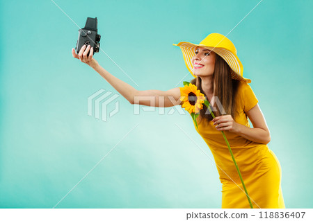 Summer woman holds sunflower old camera 118836407