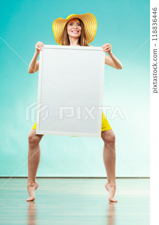 Woman in bikini holds blank presentation board. Woman in bikini holds blank presentation board. 118836446
