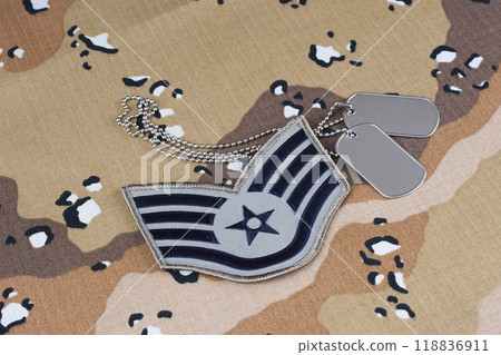 US AIR FORCE Staff Sergeant rank patch and dog tags on desert camouflage uniform background 118836911