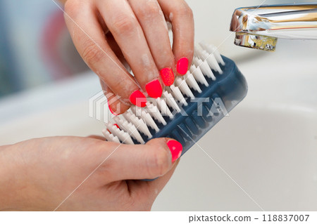 Female washing her hands, using soap brush Female washing her hands, using soap brush 118837007
