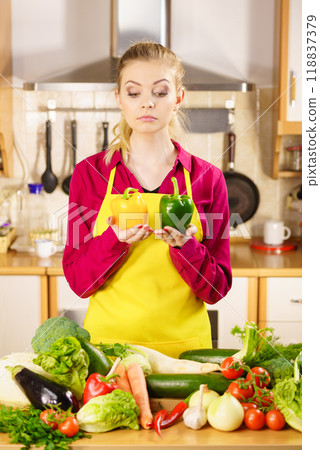 Woman holding bell peppers paprika thinking Woman holding bell peppers paprika thinking 118837379