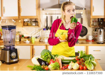 Funny woman taking bite of bell pepper Funny woman taking bite of bell pepper 118837380