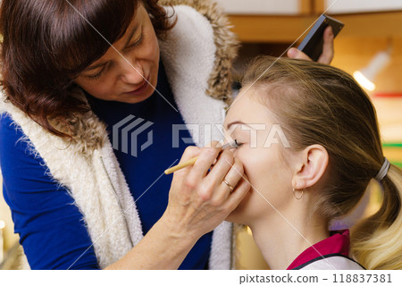 Woman getting eyes make up done by artist Woman getting eyes make up done by artist 118837381