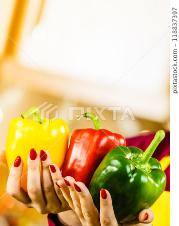 Woman holding bell peppers paprika Woman holding bell peppers paprika 118837397
