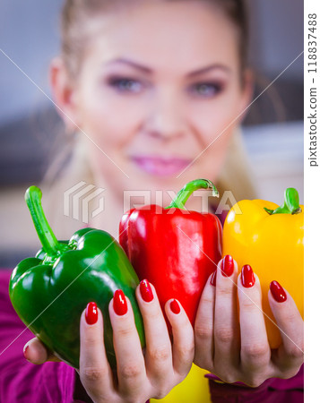 Woman holding bell peppers paprika Woman holding bell peppers paprika 118837488