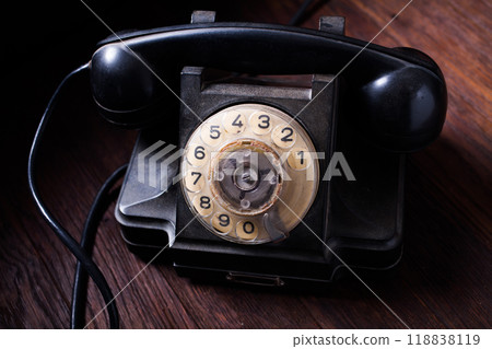 Noir concept - antique retro rotary phone on wooden table Noir concept - antique retro rotary phone on wooden table 118838119