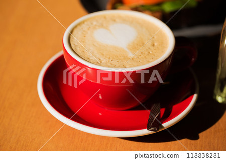 A red coffee cup with with cappuccino A red coffee cup with with cappuccino 118838281