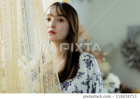 A woman by the window A woman by the window 118838713