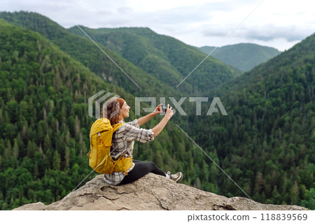 Young traveler admiring the landscape of the high Tatras. Beautiful woman on top of the mountain 118839569