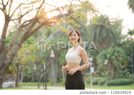 sportswoman with white sportswear in public park. 118839929