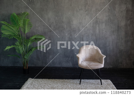 Light vintage armchair in the interior of a gray room 118840273