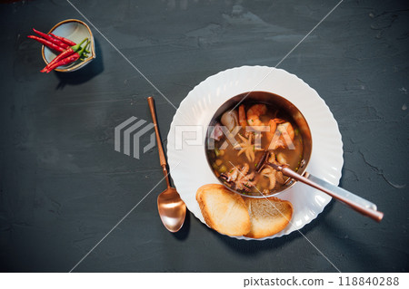plate soup with sea products with bread as background 118840288