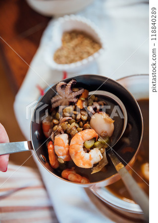 plate soup with sea products with bread as background 118840289