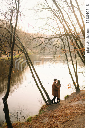 Young couple in love walking in the park on a autumn day. Enjoying time together. 118840348