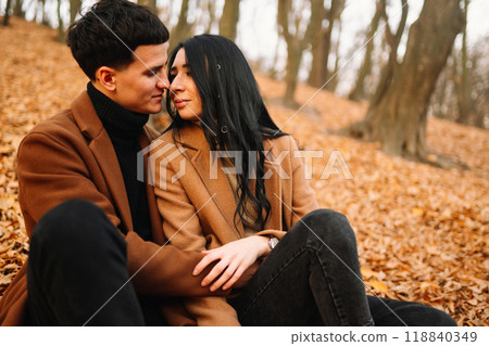 Young couple in love walking in the park on a autumn day. Enjoying time together. 118840349