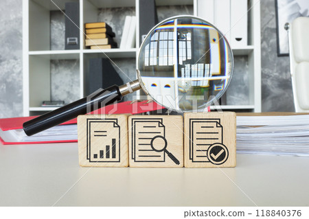 Certification and audit symbols next to a magnifying glass. Certification and audit symbols next to a magnifying glass. 118840376