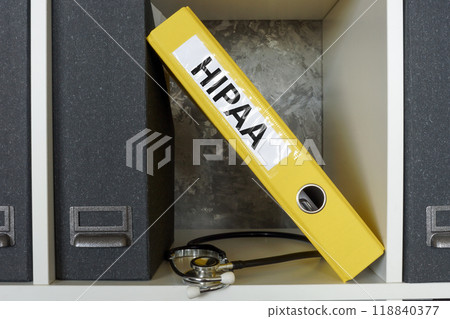Folder with HIPAA or Health Insurance Portability and Accountability Act on a shelf. Patient privacy protection. Folder with HIPAA or Health Insurance Portability and Accountability Act on a shelf. Patient privacy protection. 118840377