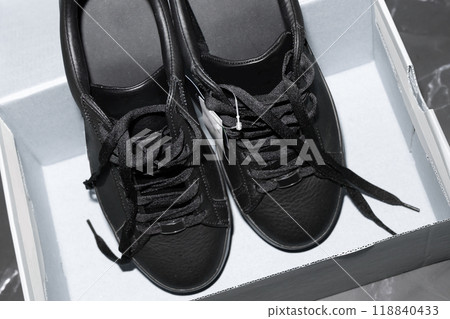 New black sports sneakers with laces in the box. New black sports sneakers with laces in the box. 118840433