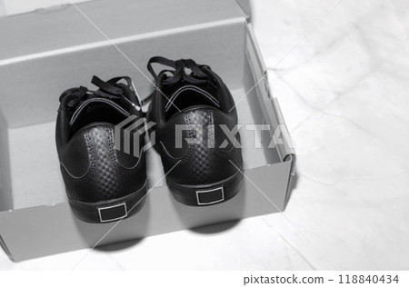 New black sports sneakers with laces in the box. New black sports sneakers with laces in the box. 118840434