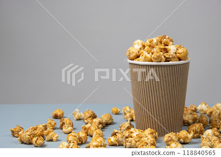 Sweet caramelized popcorn in a bucket. Place for text 118840565