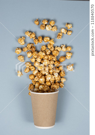 Sweet caramelized popcorn spilled out of the glass. 118840570