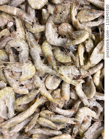 Lots of frozen unpeeled shrimp top view 118840580
