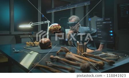Archaeologist in VR headset examines fossil skull in augmented reality 118841923