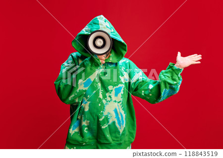 Man in green hoodie talking in megaphone against red studio background. Weekly Specials Promotion, offers background 118843519