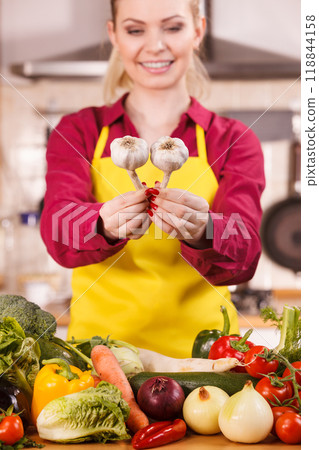 Woman holding two garlic Woman holding two garlic 118844158