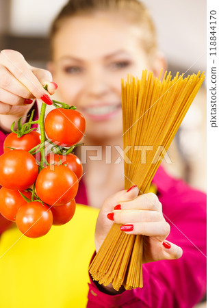 Woman holding pasta and tomatoes 118844170