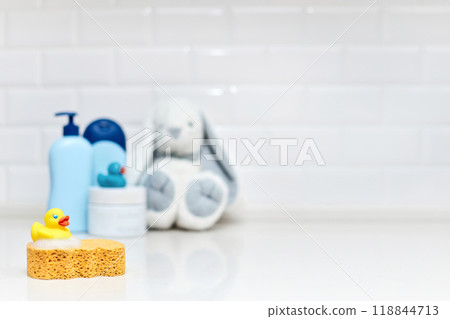 Yellow rubber duck, soap, bath foam on bath background, baby bath accessories 118844713