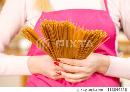 Woman holding long pasta 118844828