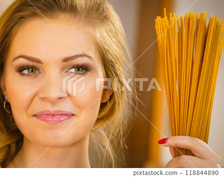 Woman holding long pasta Woman holding long pasta 118844890