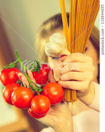 Woman holding pasta, tomatoes and garlic Woman holding pasta, tomatoes and garlic 118844895