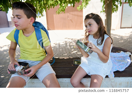 Children enjoying a snack break outdoors on a sunny day Children enjoying a snack break outdoors on a sunny day 118845757