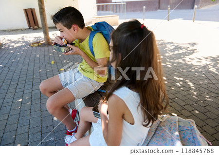 Children enjoying lunch outdoors on a sunny day Children enjoying lunch outdoors on a sunny day 118845768