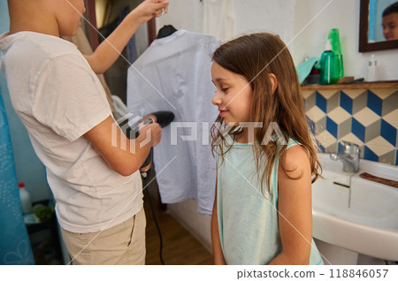 Children ironing clothes together in a cozy bathroom setting 118846057