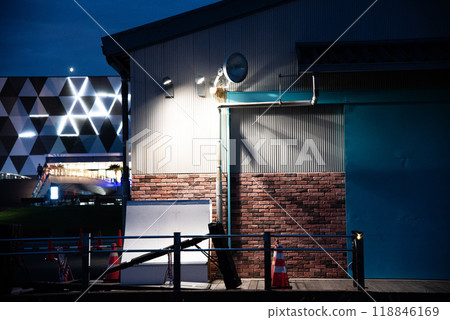 Illuminated warehouse at night 118846169