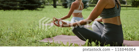 Website banner of women sitting on grass during yoga in park Website banner of women sitting on grass during yoga in park 118846864