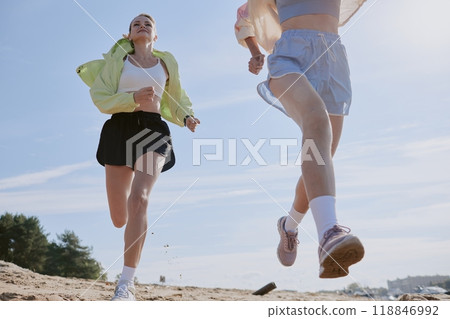 Low angle shot of toned women running on stoned path before main train in local park Low angle shot of toned women running on stoned path before main train in local park 118846992